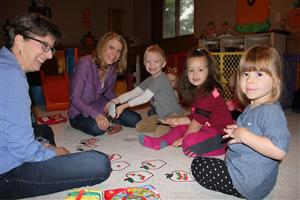 Child Care Collaborative teacher and child care provider with young children