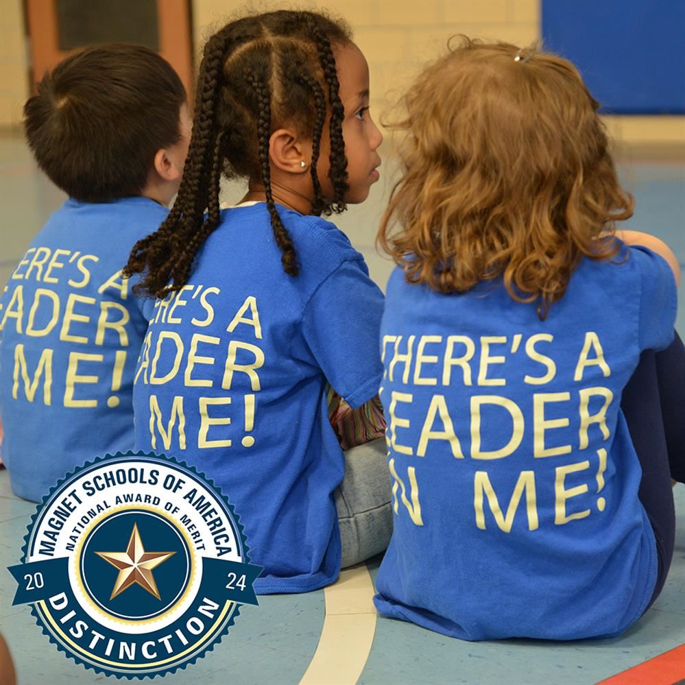  backs of students with the slogan There's a leader in me! on their shirts