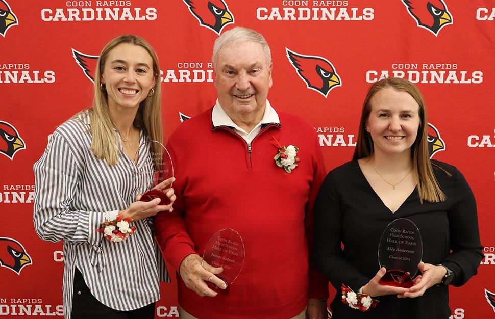 Rachel Guentzel, Jim Roback, Ally Anderson pictured in front of red Coon Rapids Cardinals backdrop