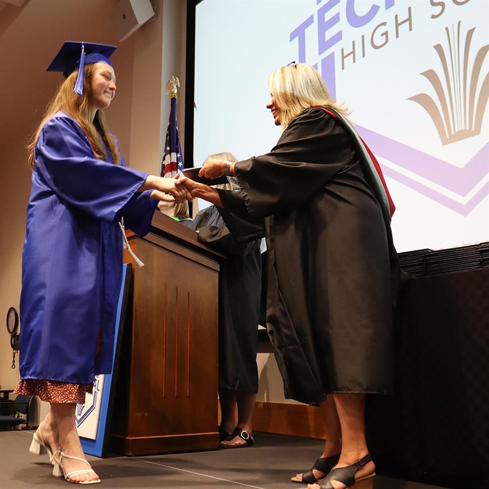  2024 Anoka-Hennepin Technical High School graduate walking across the graduation stage