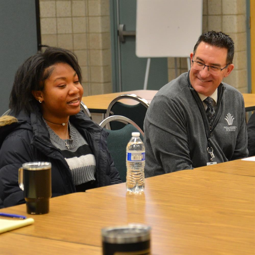  McIntyre smiling while listening to a student 