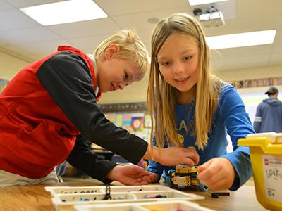 students building with LEGOs